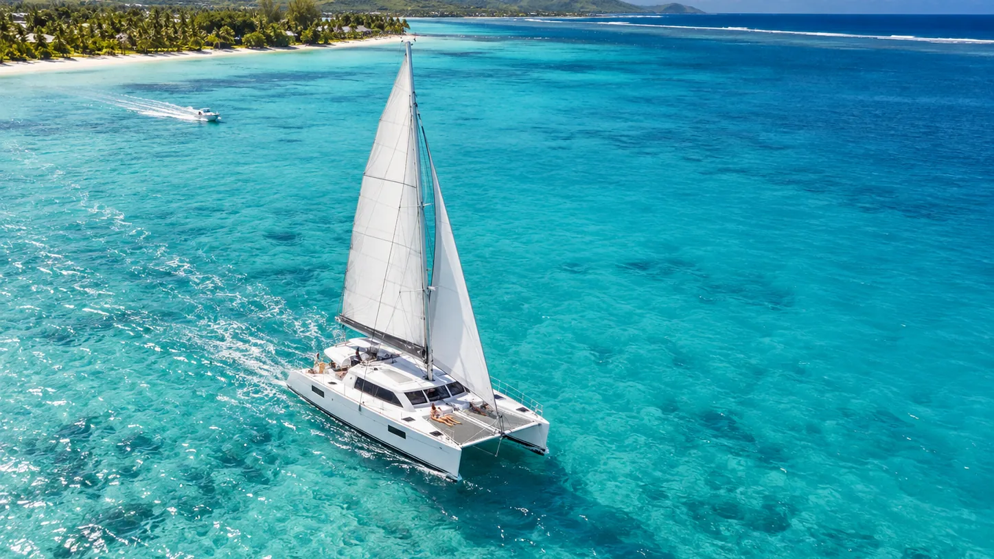 A catamaran sailing across the turquoise lagoon of Mauritius
