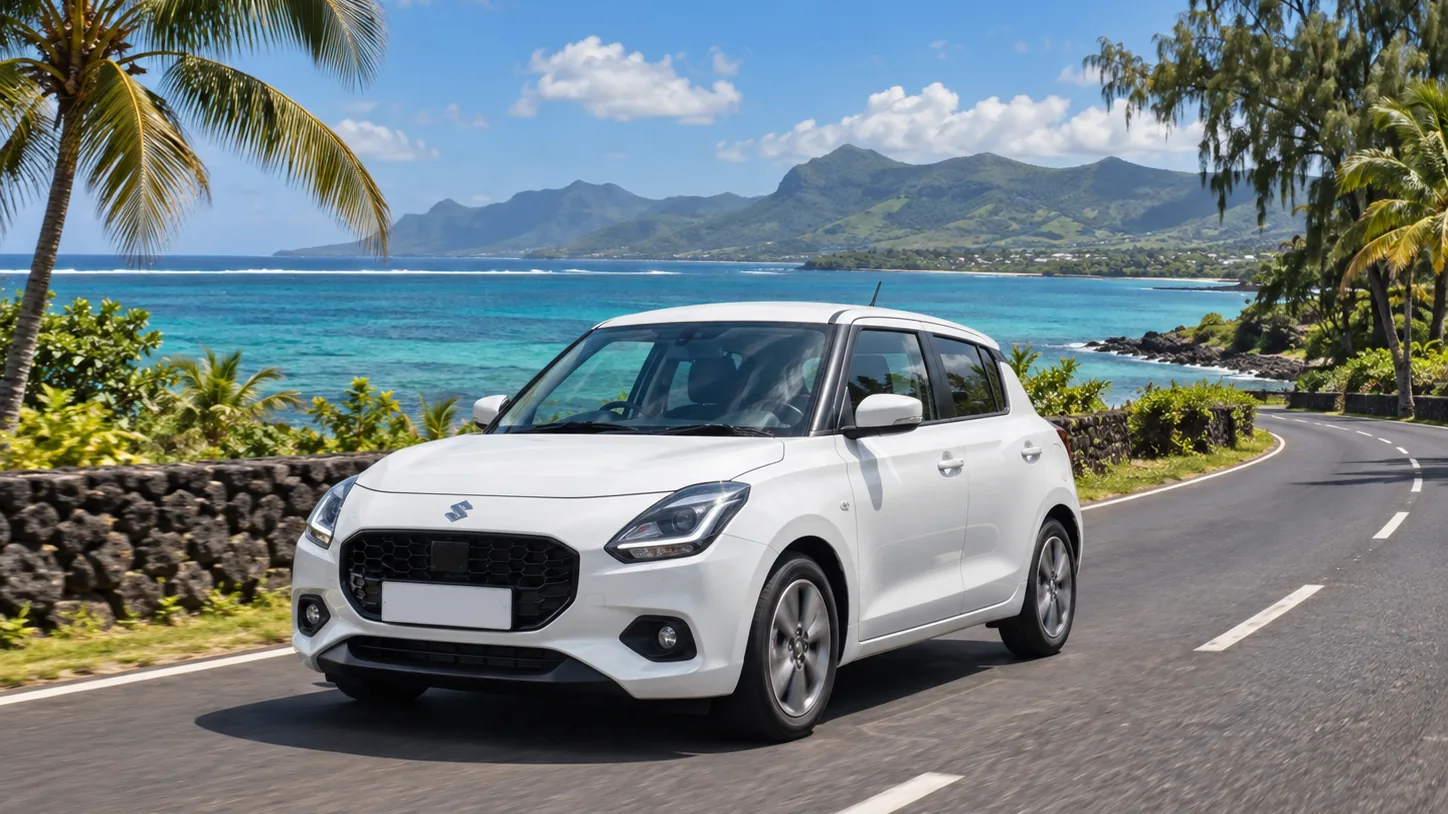 A white Suzuki on a coastal road beneath the mountains of Mauritius
